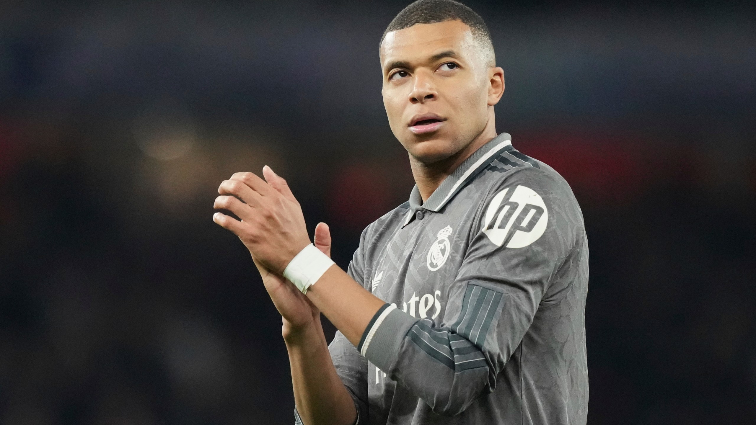 FILE - Real Madrid's Kylian Mbappe applauds fans at the end of the Champions League quarterfinal first leg soccer match between Arsenal and Real Madrid at the Emirates Stadium in London, Tuesday, April 8, 2025. Kylian Mbappé's legal team is going on the attack to try and solve the legal dispute between the World Cup winner and his former club PSG. (AP Photo/Frank Augstein, File)