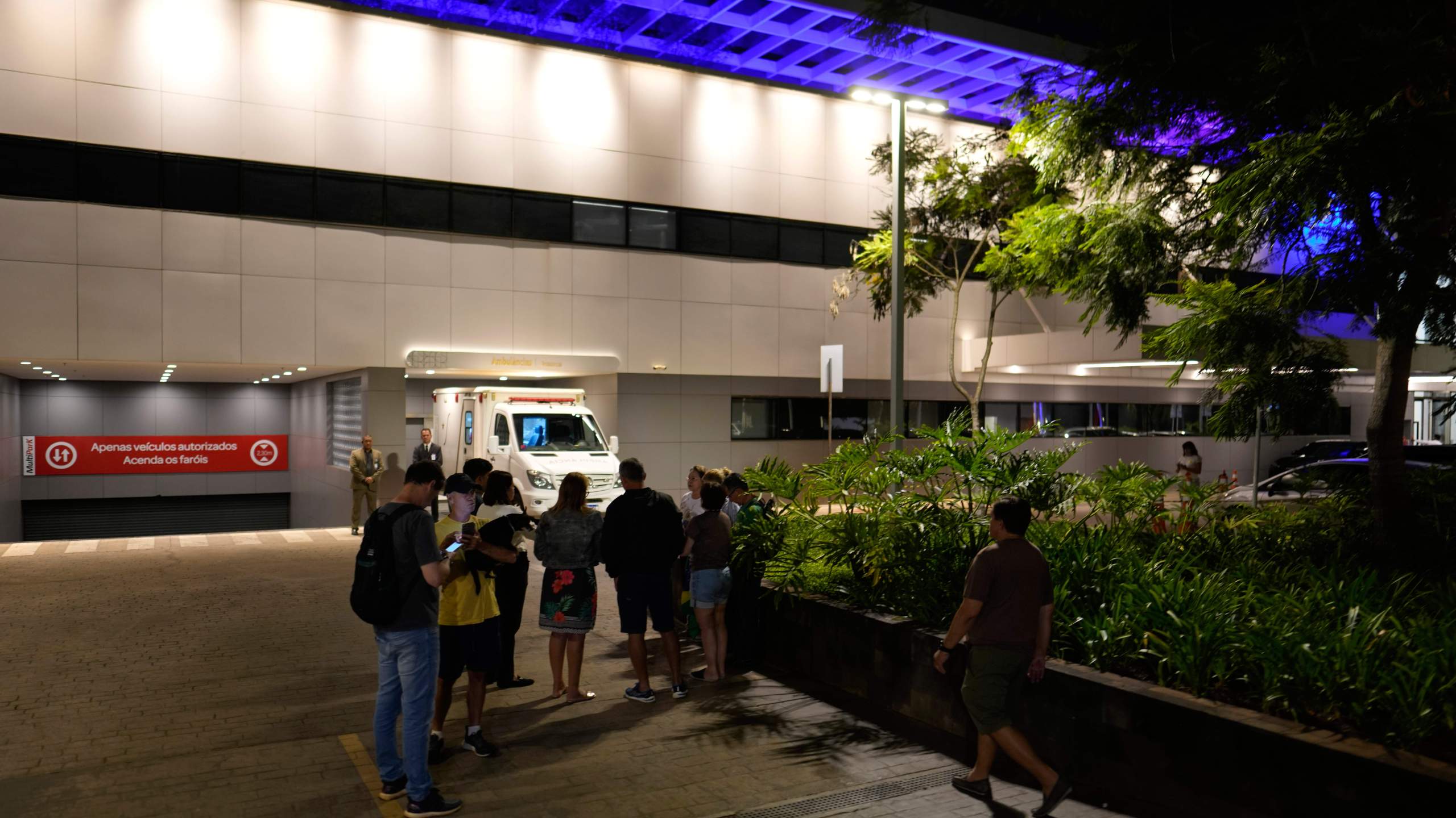 Supporters hold a vigil for former Brazilian President Jair Bolsonaro after he transferred to a DF Star hospital with abdominal pain in Brasilia, Brazil, Saturday, April 12, 2025. (AP Photo/Eraldo Peres)