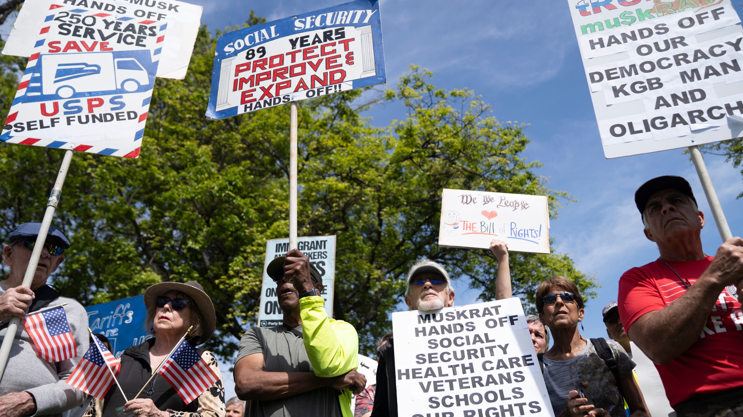 Demonstrators rally against President Donald Trump and Tesla CEO Elon Musk in San Jose, Calif., as part of a national day of action on Saturday, April 5, 2025. (AP Photo/Emily Steinberger)