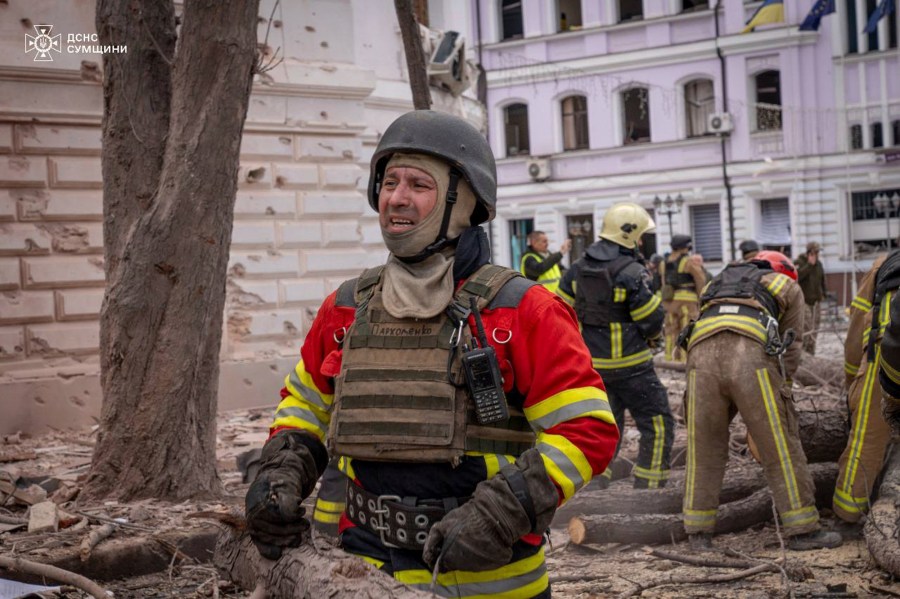 In this photo provided by the Ukrainian Emergency Service, searchers clear the rubble following Russia's missile attack that killed at least 32 civilians in Sumy, Ukraine, Sunday, April 13, 2025. (Ukrainian Emergency Service via AP)