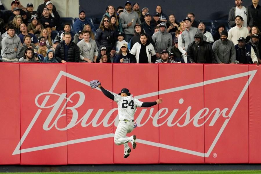 New York Yankees outfielder Jasson Domínguez makes a leaping catch during the fourth inning of a baseball game against the Kansas City Royals Monday, April 14, 2025, in New York. (AP Photo/Seth Wenig)