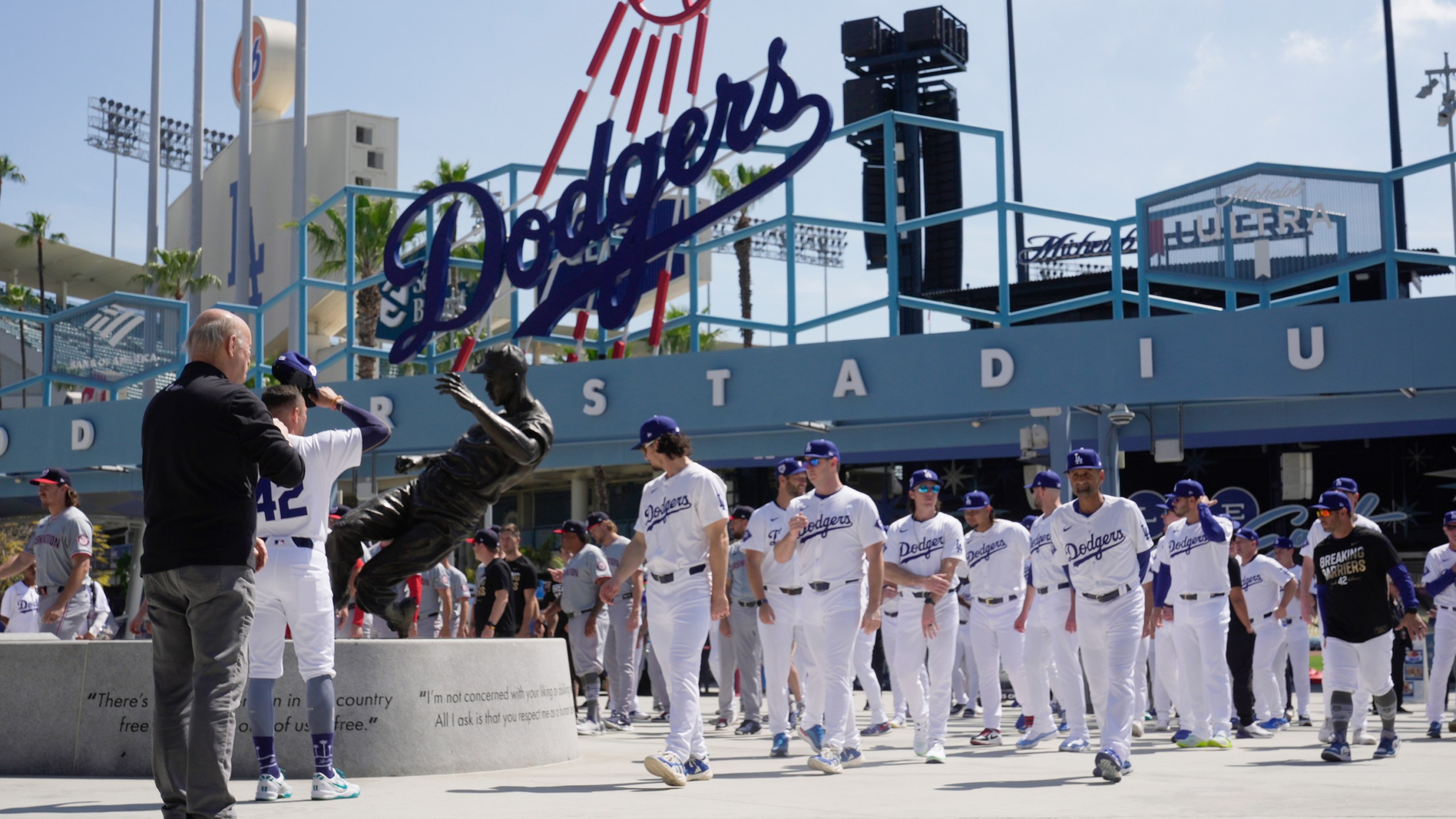 FILE - Los Angeles Dodgers and Washington Nationals team members arrive to celebrate Jackie Robinson Tribute Day before a baseball game at Dodger Stadium in Los Angeles, on Monday, April 15, 2024. (AP Photo/Damian Dovarganes, File)