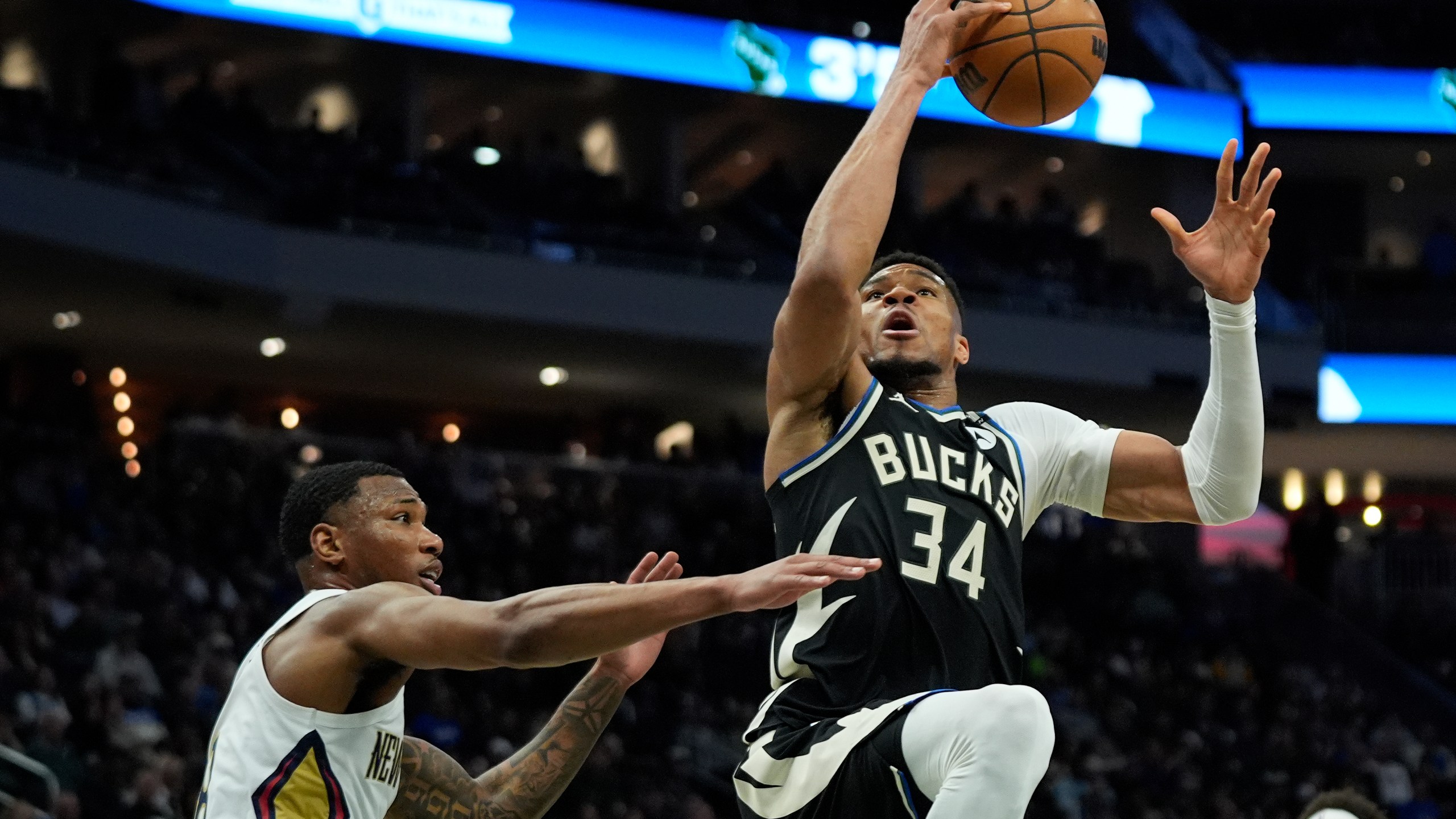 Milwaukee Bucks' Giannis Antetokounmpo (34) drives to the basket against New Orleans Pelicans' Jamal Cain, left, during the first half of an NBA basketball game Thursday, April 10, 2025, in Milwaukee. (AP Photo/Aaron Gash)