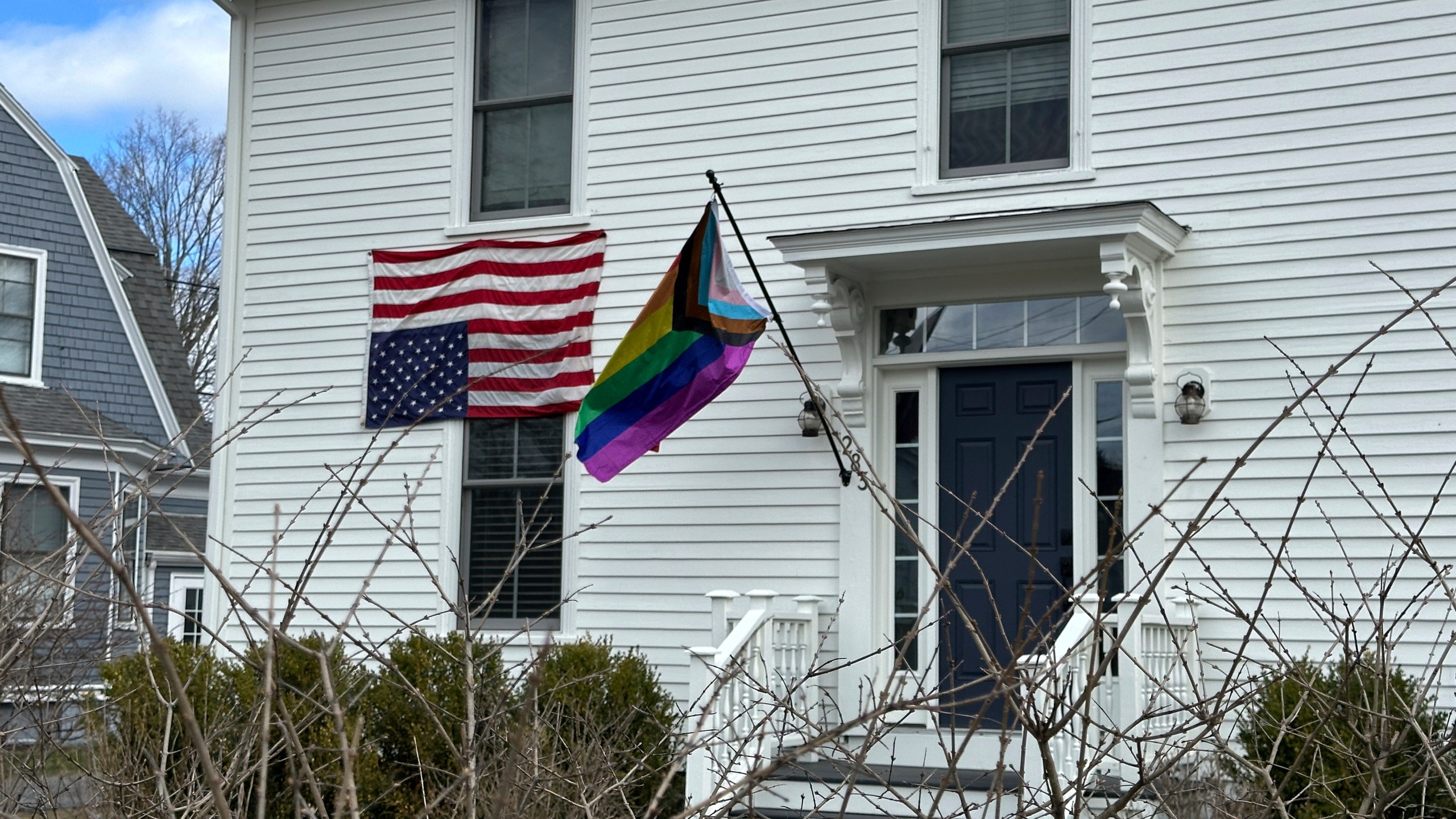 This house in Cumberland, Maine, shows a home with an LGBTQ pride flag and an upside down American flag, Wednesday, Aprill 16, 2025. (AP Photo/Patrick Whittle)