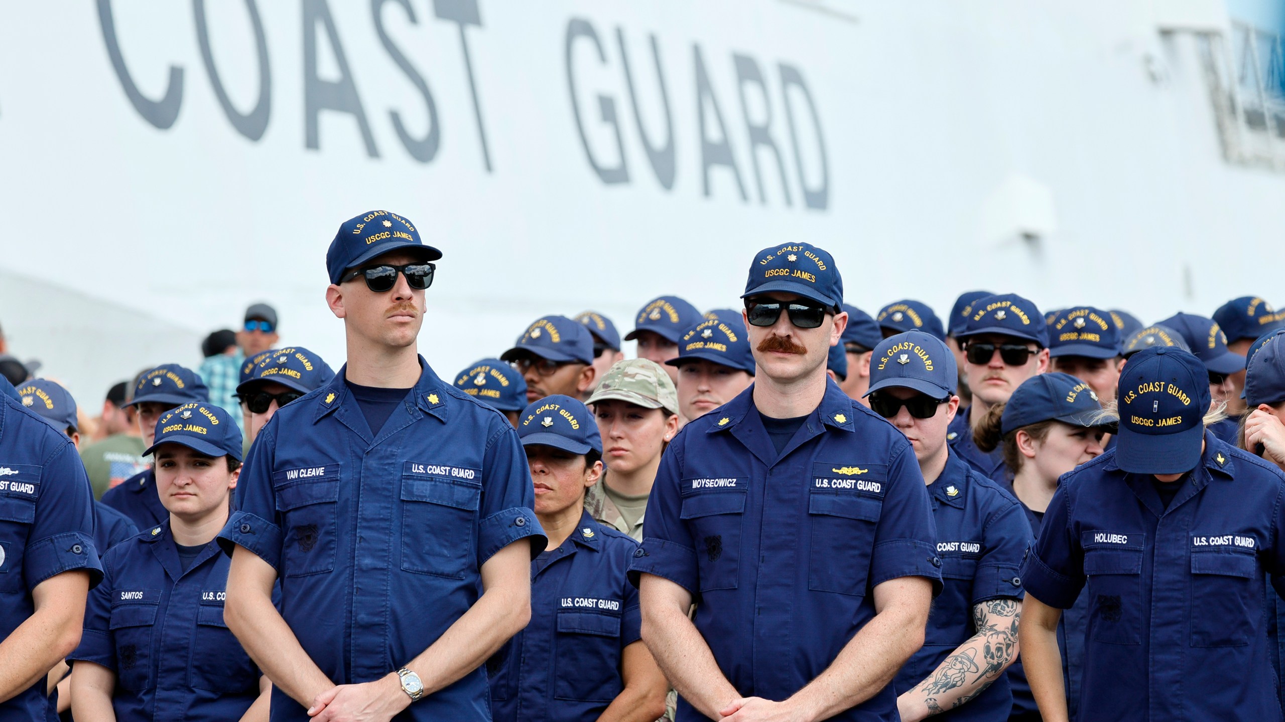 Members of the U.S. Coast Guard from U.S. Coast Guard cutter James await the arrival of U.S. Attorney General Pam Bondi and FBI Director Kash Patel for a news conference on Wednesday, April 9, 2025, at Port Everglades, Fla. (Amy Beth Bennett /South Florida Sun-Sentinel via AP)