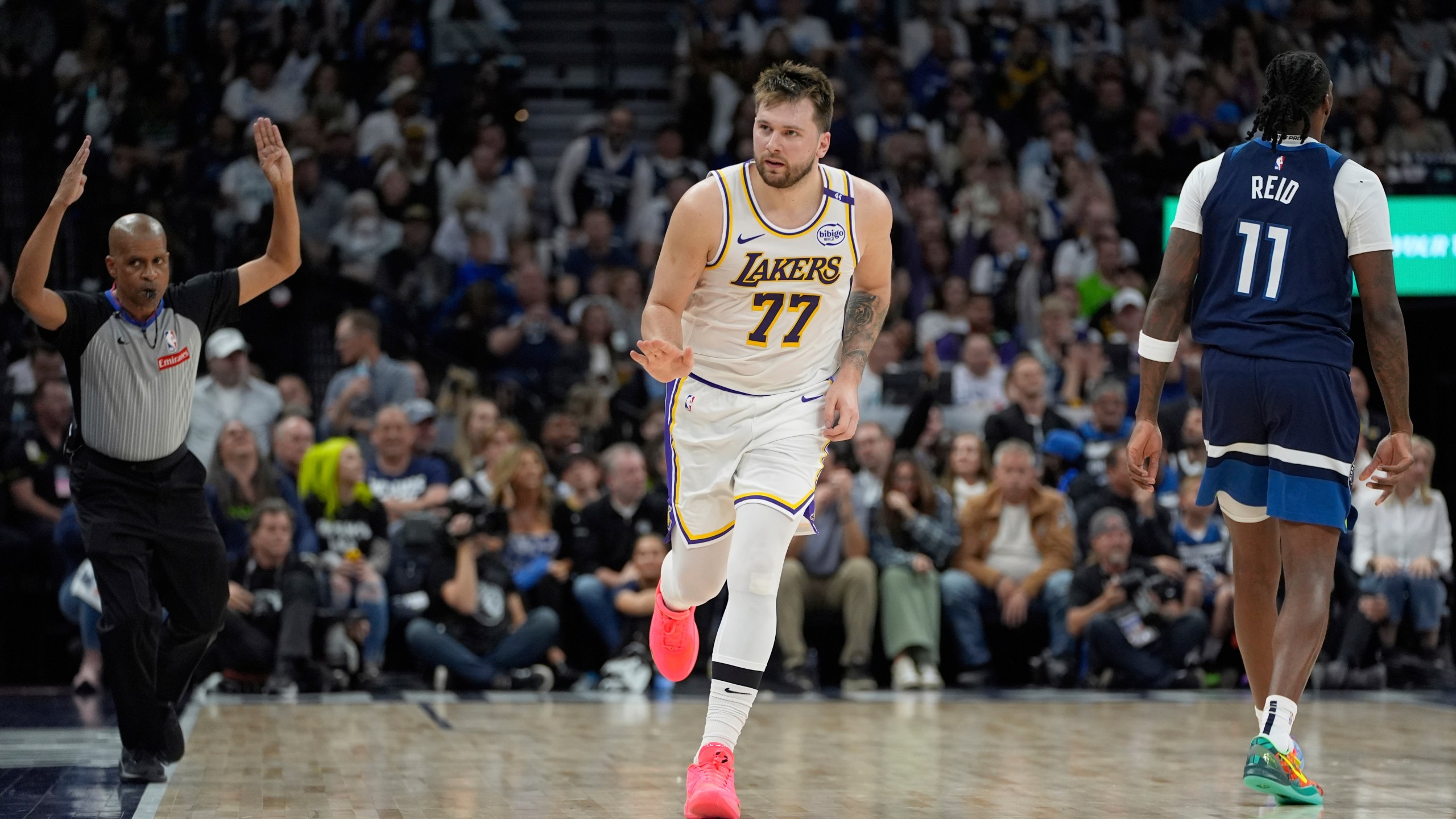 Los Angeles Lakers guard Luka Doncic (77) gestures after making a 3-point basket during the first half of Game 4 of an NBA basketball first-round playoff series against the Minnesota Timberwolves, Sunday, April 27, 2025, in Minneapolis. (AP Photo/Abbie Parr)
