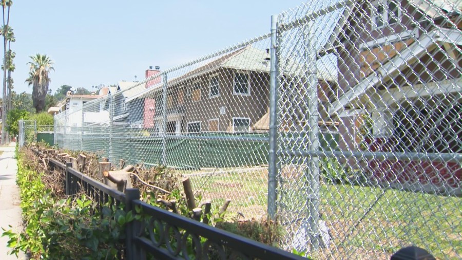 The street and empty properties are littered with trash and debris from transients and squatters who have taken over the vacant Hollywood buildings on Wilton Place. (KTLA)