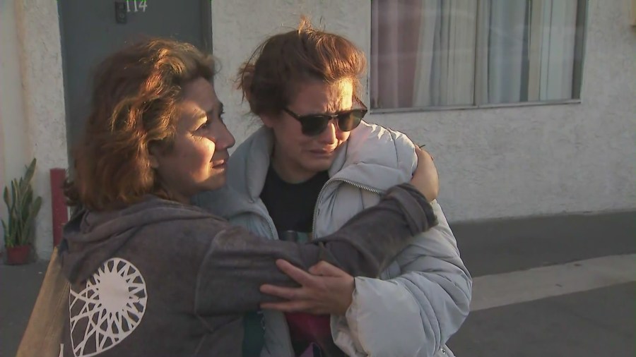 The boy's mother, Gladys Maribel Bautista, (right) is comforted by a loved one during a candlelight vigil held to honor Oscar Hernandez in Sun Valley on April 4, 2025. (KTLA)