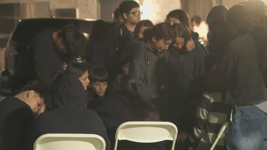 Oscar Hernandez's friends and loved ones are seen at a candlelight vigil held outside his Sun Valley home on April 4, 2025. (KTLA)