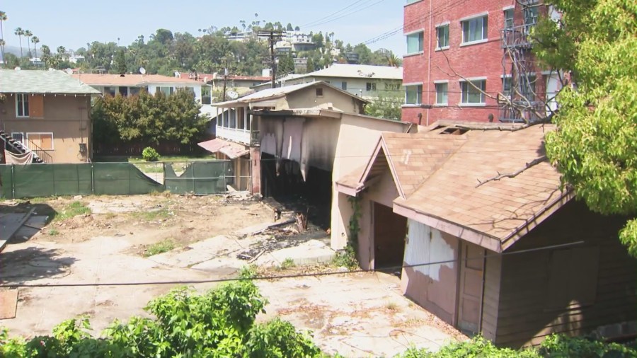 The backyard view of a vacant building on Wilton Place in Hollywood that neighbors said have attracted a constant stream of homeless people, dangerous criminal activity and even some visitors who have started fires. (KTLA)