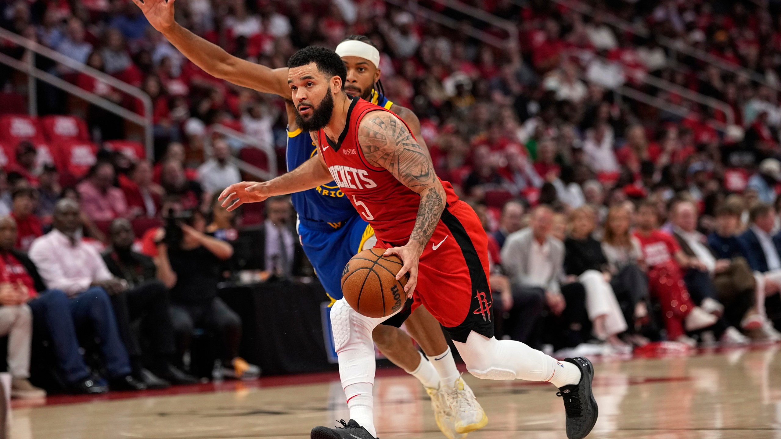 Houston Rockets guard Fred VanVleet (5) drives past Golden State Warriors guard Moses Moody during the first half of Game 5 of an NBA basketball first-round playoff series, Wednesday, April 30, 2025, in Houston. (AP Photo/David J. Phillip)