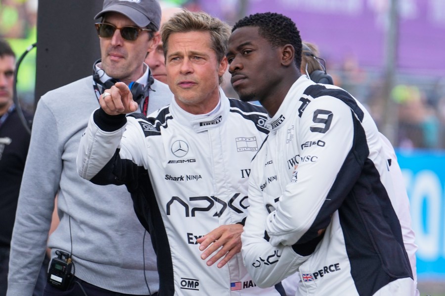FILE - Actors Brad Pitt, left, and Damson Idris appear on the grid before the British Formula One Grand Prix race at the Silverstone racetrack, Silverstone, England, on July 9, 2023, for the filming of "F1." (AP Photo/Luca Bruno, File)