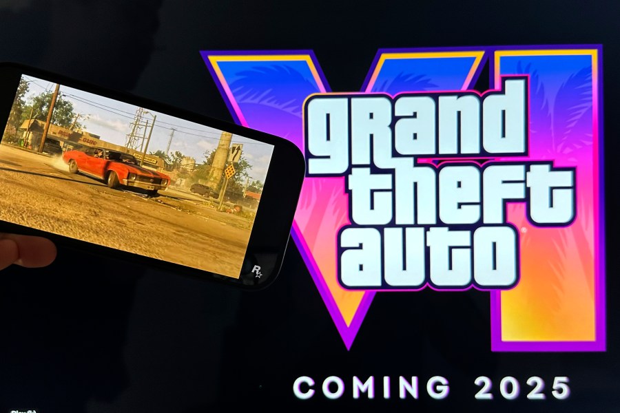FILE - Scenes from the trailer of Grand Theft Auto VI are shown on a smartphone and monitor in New York on Tuesday, Dec. 5, 2023. (AP Photo/Peter Morgan, File)