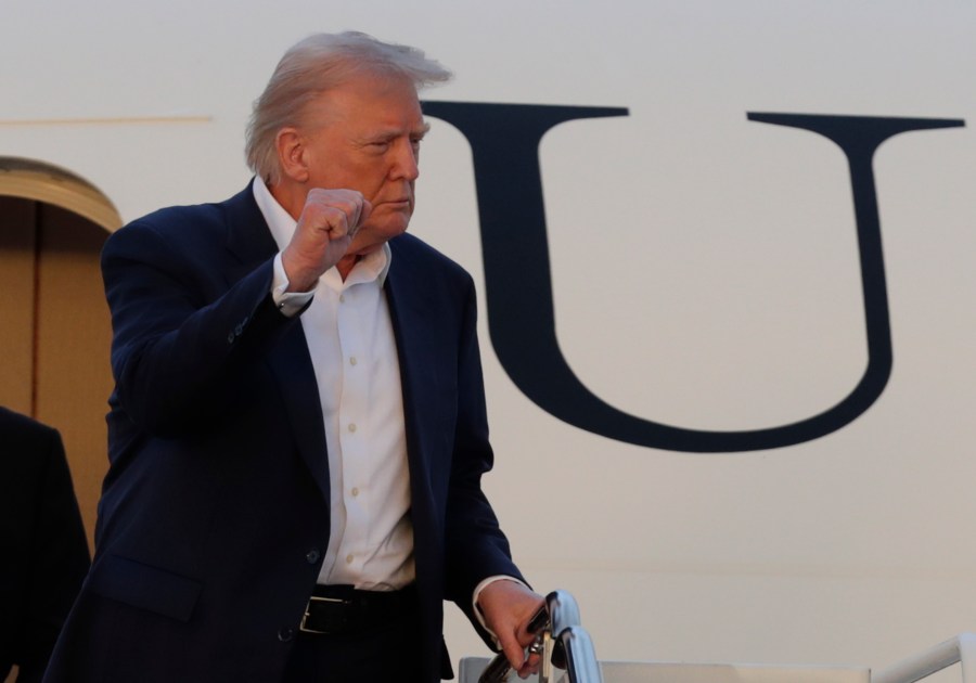 President Donald Trump gestures from the stairs of Air Force One upon his arrival at Joint Base Andrews, Md., Sunday, May 4, 2025. (AP Photo/Luis M. Alvarez)
