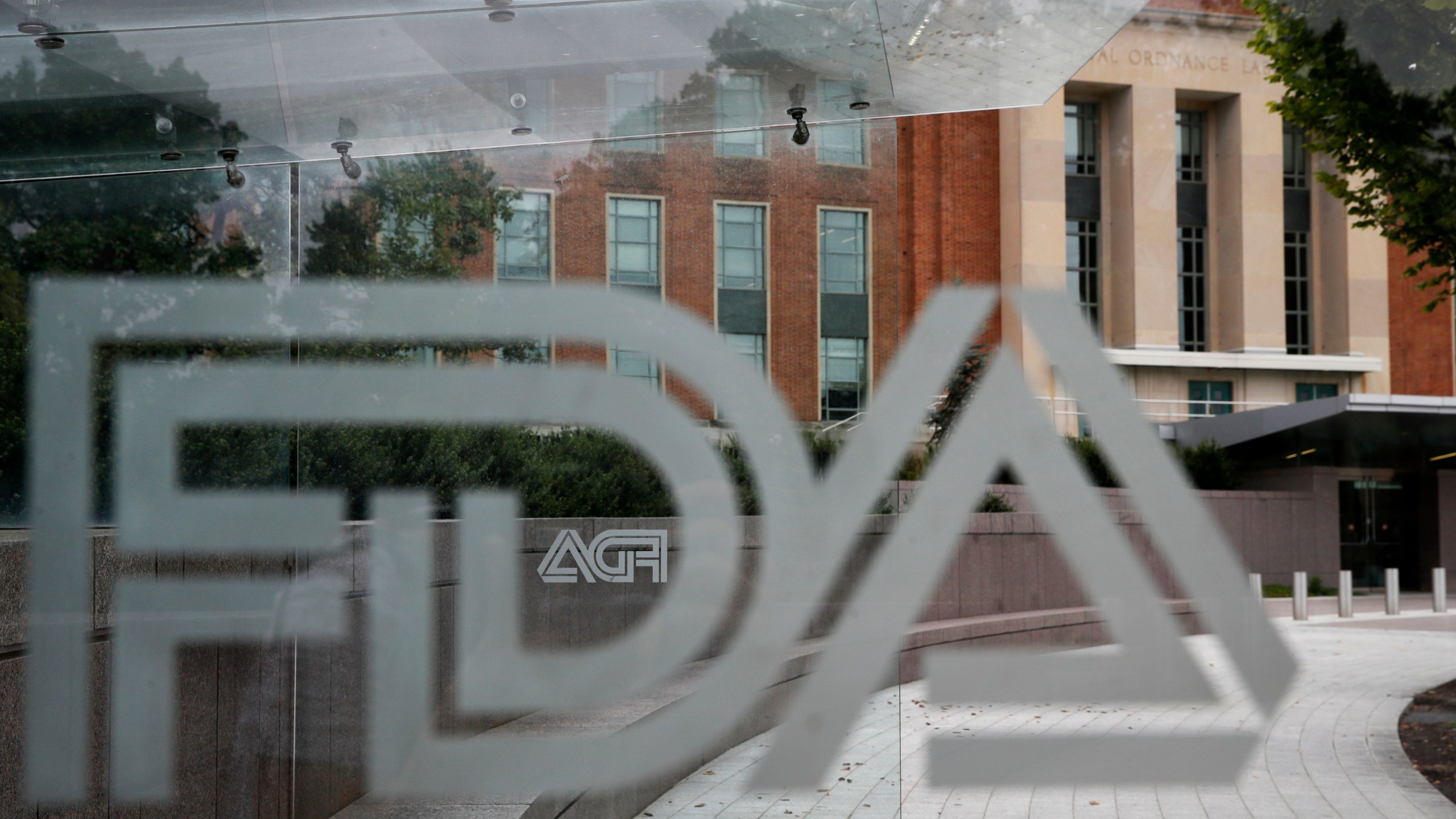 FILE - The U.S. Food and Drug Administration building behind FDA logos at a bus stop on the agency's campus in Silver Spring, Md, Thursday, Aug. 2, 2018. (AP Photo/Jacquelyn Martin, File)