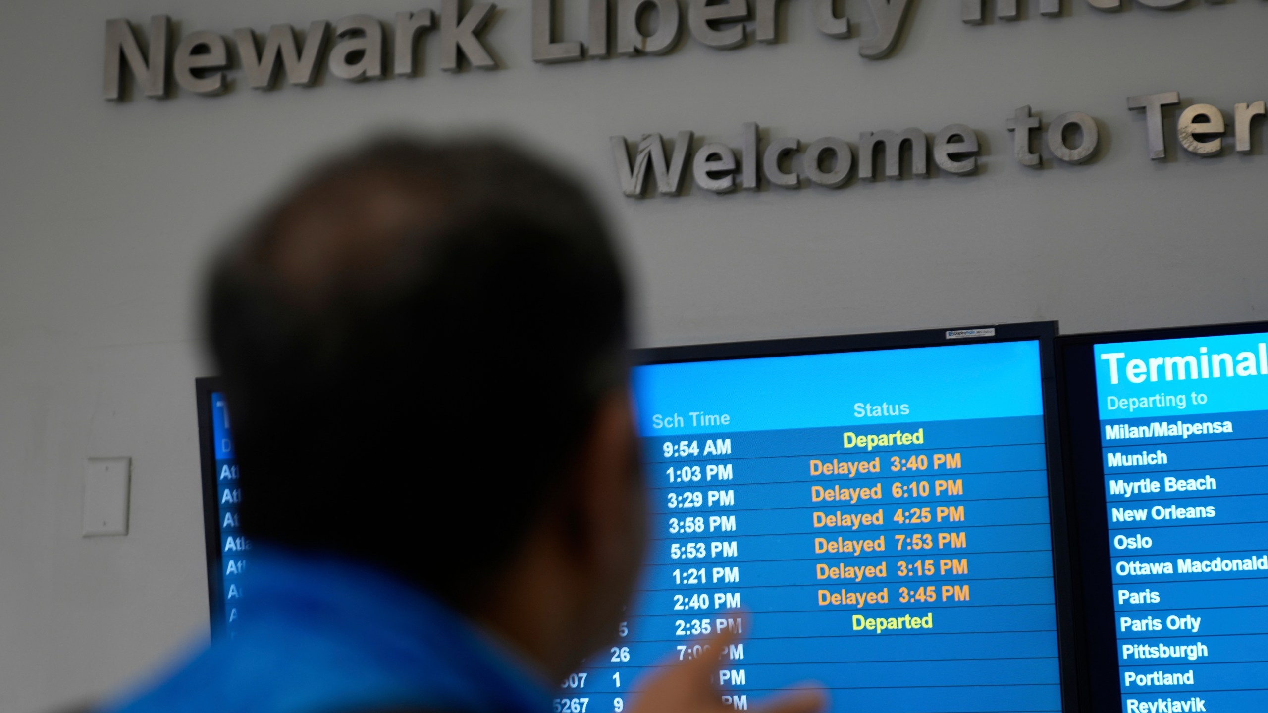 A display shows the status of flights at Newark Liberty International Airport in Newark, N.J., Monday, May 5, 2025. (AP Photo/Seth Wenig)