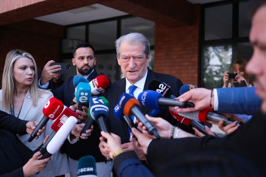 Sali Berisha, center, leader of Democratic Party of Albania, makes statements outside a voting station during a general election where rival Socialist Edi Rama is seeking a fourth term as Albania's prime minister in Tirana, Albania Sunday, May 11, 2025. (AP Photo)