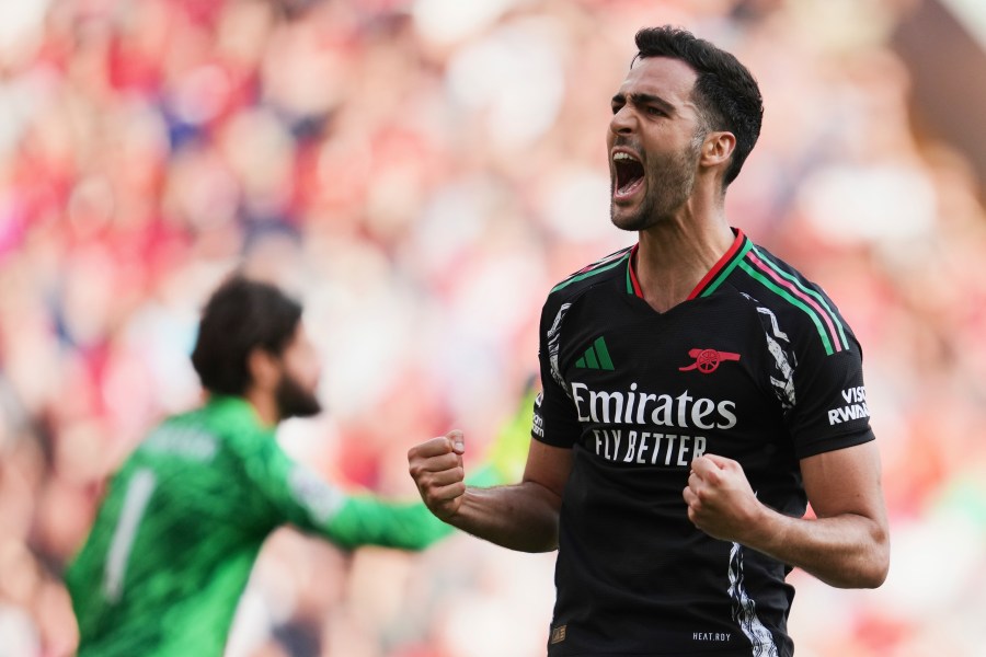 Arsenal's Mikel Merino celebrates after scoring his side's second goal during the English Premier League soccer match between Liverpool and Arsenal, at Anfield stadium in Liverpool, England, Sunday, May 11, 2025. (AP Photo/Jon Super)