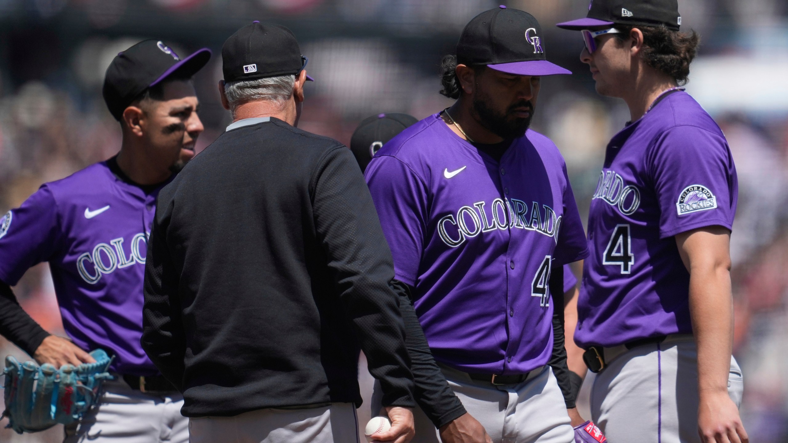 Colorado Rockies pitcher Germán Márquez, middle right, walks toward the dugout as manager Bud Black, middle left, makes a pitching change during the fifth inning of a baseball game against the San Francisco Giants in San Francisco, Sunday, May 4, 2025. (AP Photo/Jeff Chiu)