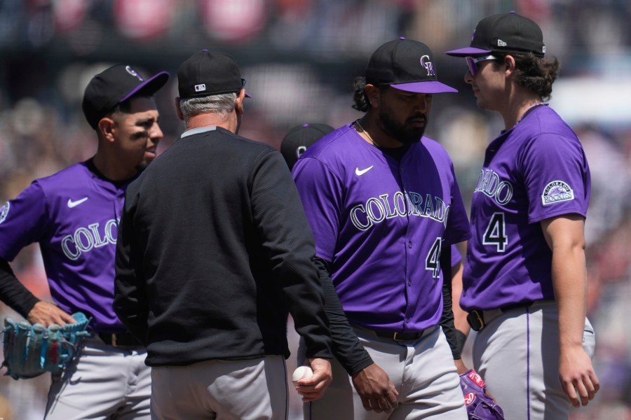 Colorado Rockies pitcher Germán Márquez, middle right, walks toward the dugout as manager Bud Black, middle left, makes a pitching change during the fifth inning of a baseball game against the San Francisco Giants in San Francisco, Sunday, May 4, 2025. (AP Photo/Jeff Chiu)