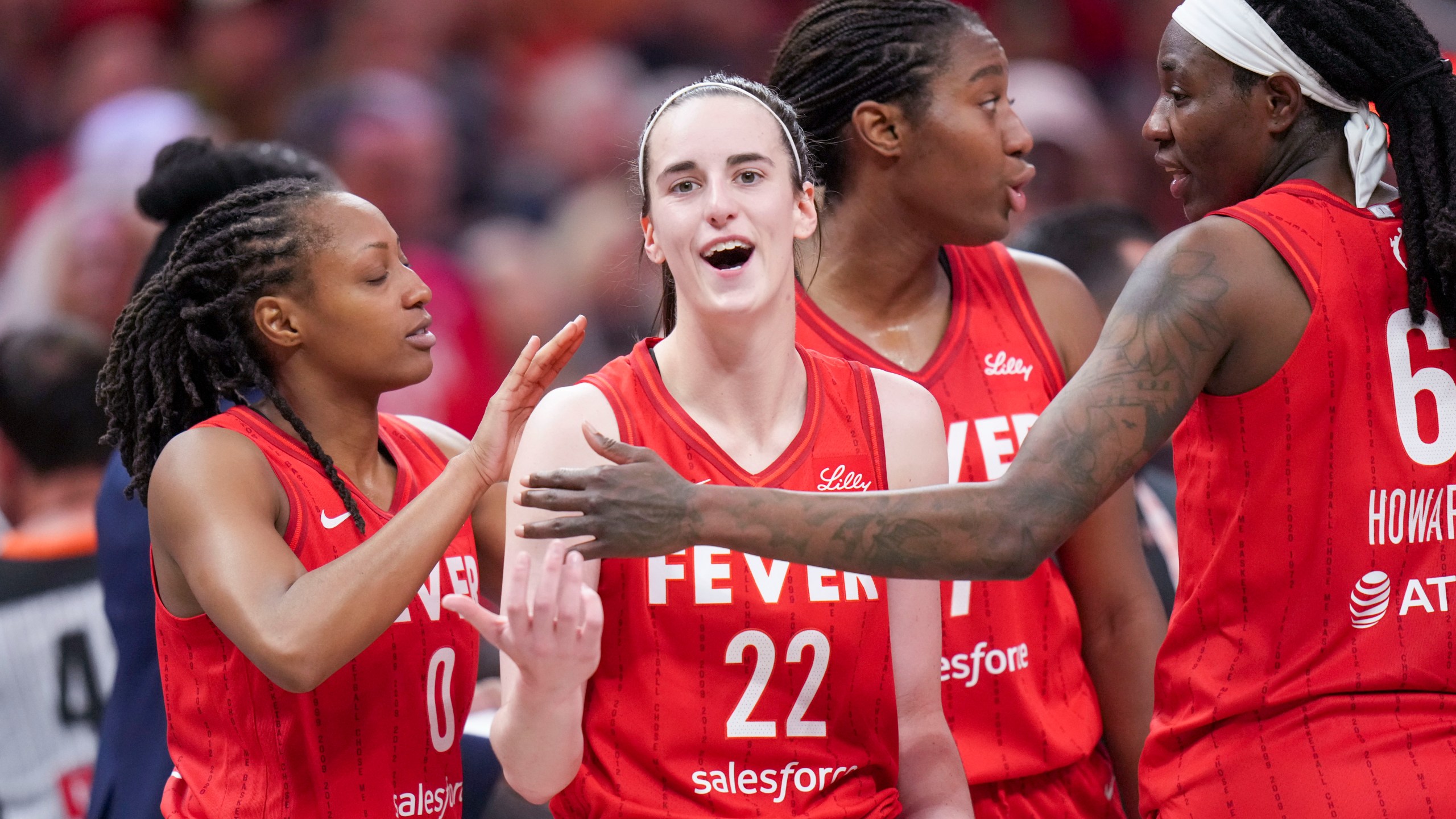 Indiana Fever guard Caitlin Clark (22) is ushered back to the bench area by teammates after being called for a flagrant foul on Chicago Sky forward Angel Reese during the second half an WNBA basketball game in Indianapolis, Saturday, May 17, 2025. (AP Photo/AJ Mast)