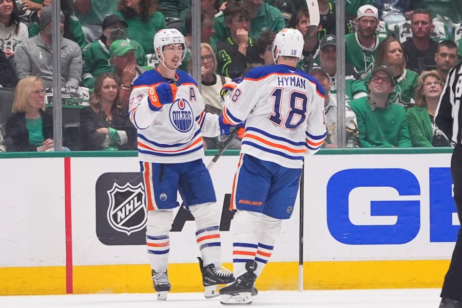 Edmonton Oilers center Ryan Nugent-Hopkins (93) celebrates after his goal with teammate Zach Hyman (18) during the first period in Game 2 of the Western Conference finals in the NHL hockey Stanley Cup playoffs against the Dallas Stars, Friday, May 23, 2025, in Dallas. (AP Photo/LM Otero)