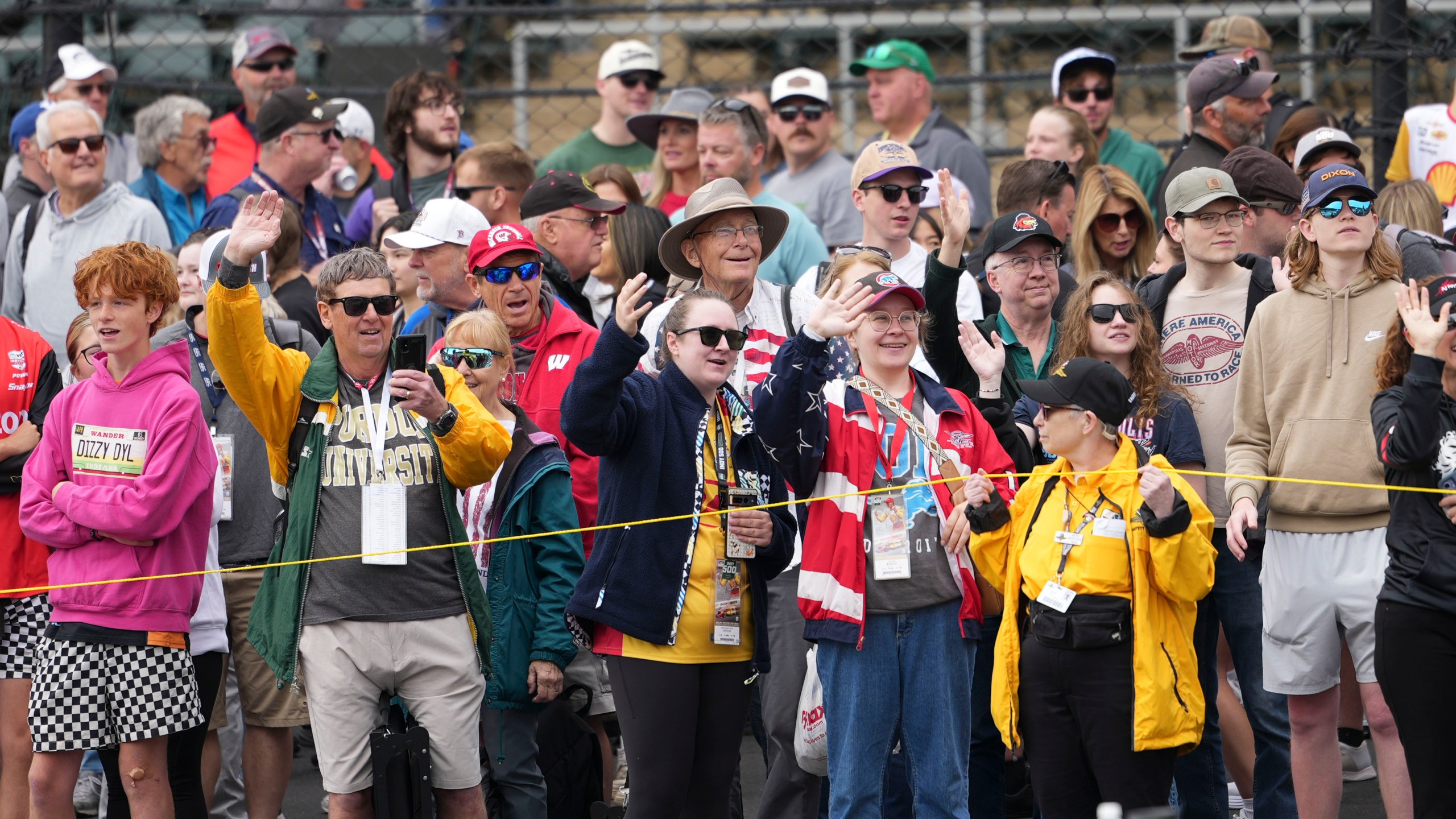Fans waive during parade laps before the start of the Indianapolis 500 auto race at Indianapolis Motor Speedway in Indianapolis, Sunday, May 25, 2025. (AP Photo/AJ Mast)