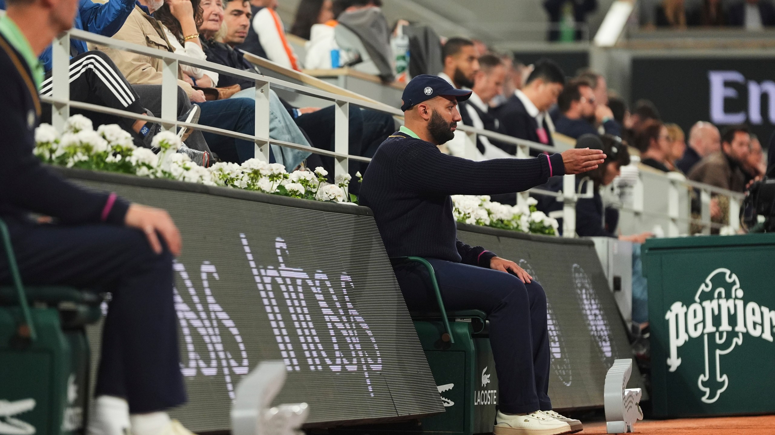 A line judge makes a call as Russia's Anastasia Pavliuchenkova plays China's Zheng Qinwen during their first round match of the French Tennis Open at the Roland Garros stadium, in Paris, Sunday May 25, 2025. (AP Photo/Lindsey Wasson)