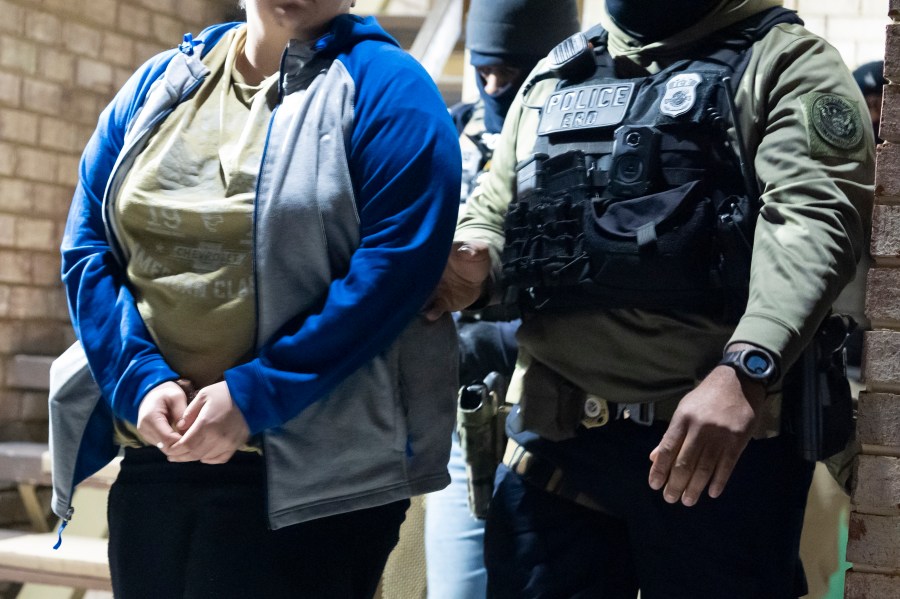 FILE - U.S. Immigration and Customs Enforcement officers detain a person, left, Monday, Jan. 27, 2025, in Silver Spring, Md. (AP Photo/Alex Brandon, File)