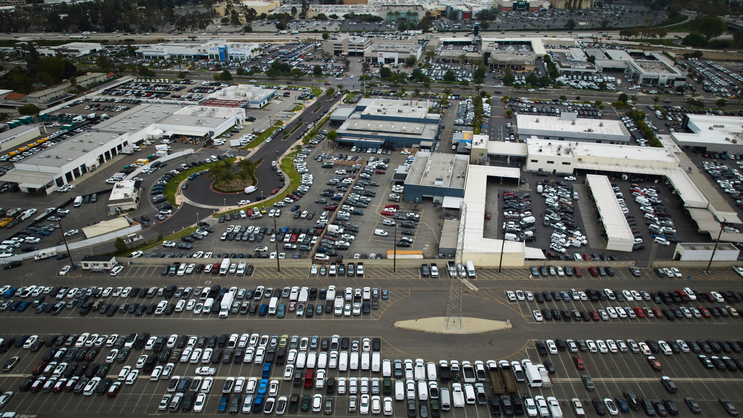 An aerial view shows auto dealerships in Cerritos, Calif., Thursday, March 27, 2025. (AP Photo/Jae C. Hong)