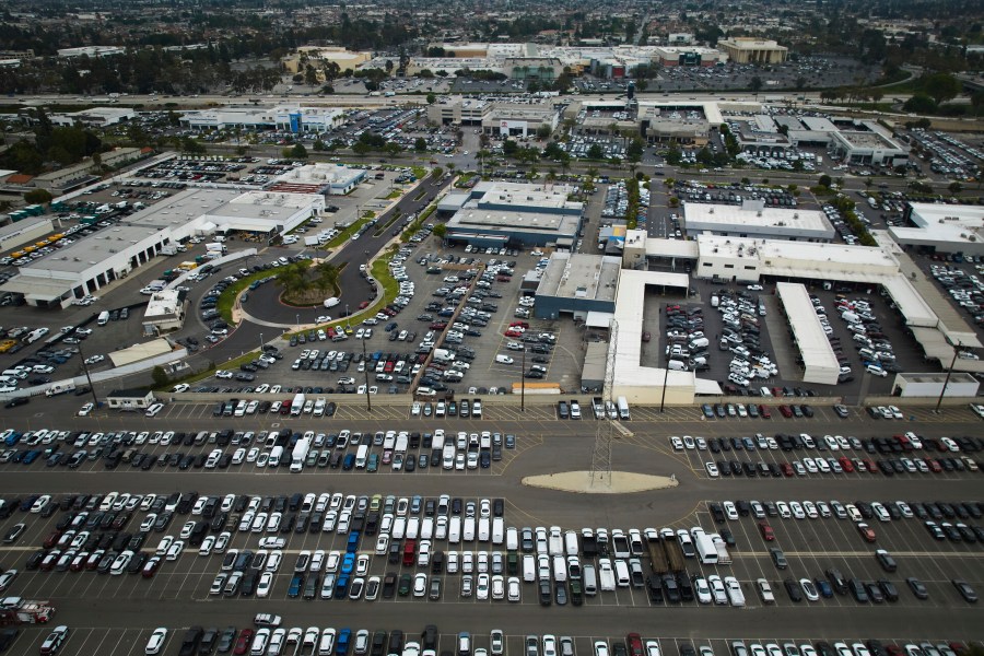 An aerial view shows auto dealerships in Cerritos, Calif., Thursday, March 27, 2025. (AP Photo/Jae C. Hong)
