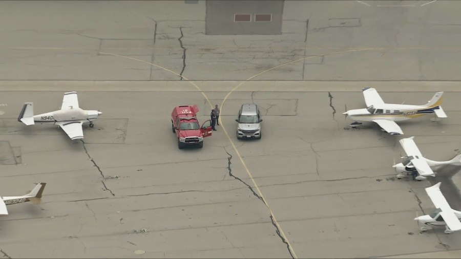 Emergency crews are seen parked on the tarmac at Fullerton Airport after a report of a possible plane crash on May 2, 2025. (KTLA)