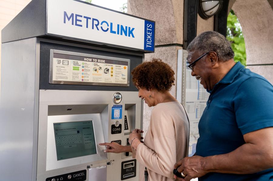 Riders purchase tickets from a Metrolink kiosk in this undated promotional image.