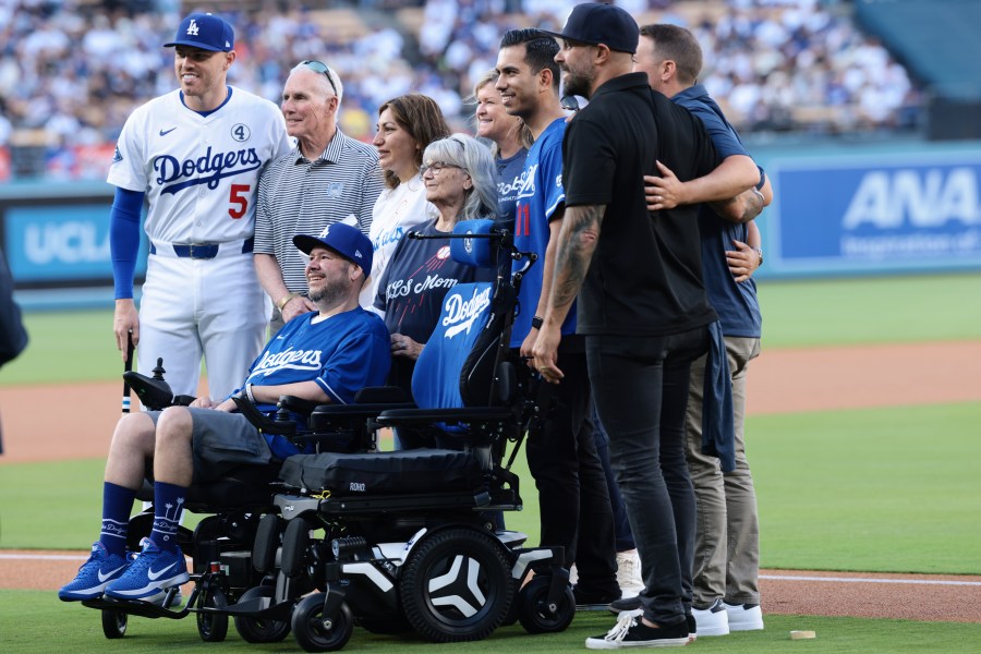 Freddie Freeman presents Jason Ramirez with a special wheelchair in a pregame ceremony at Dodger Stadium on June 2, 2025. (Getty Images)