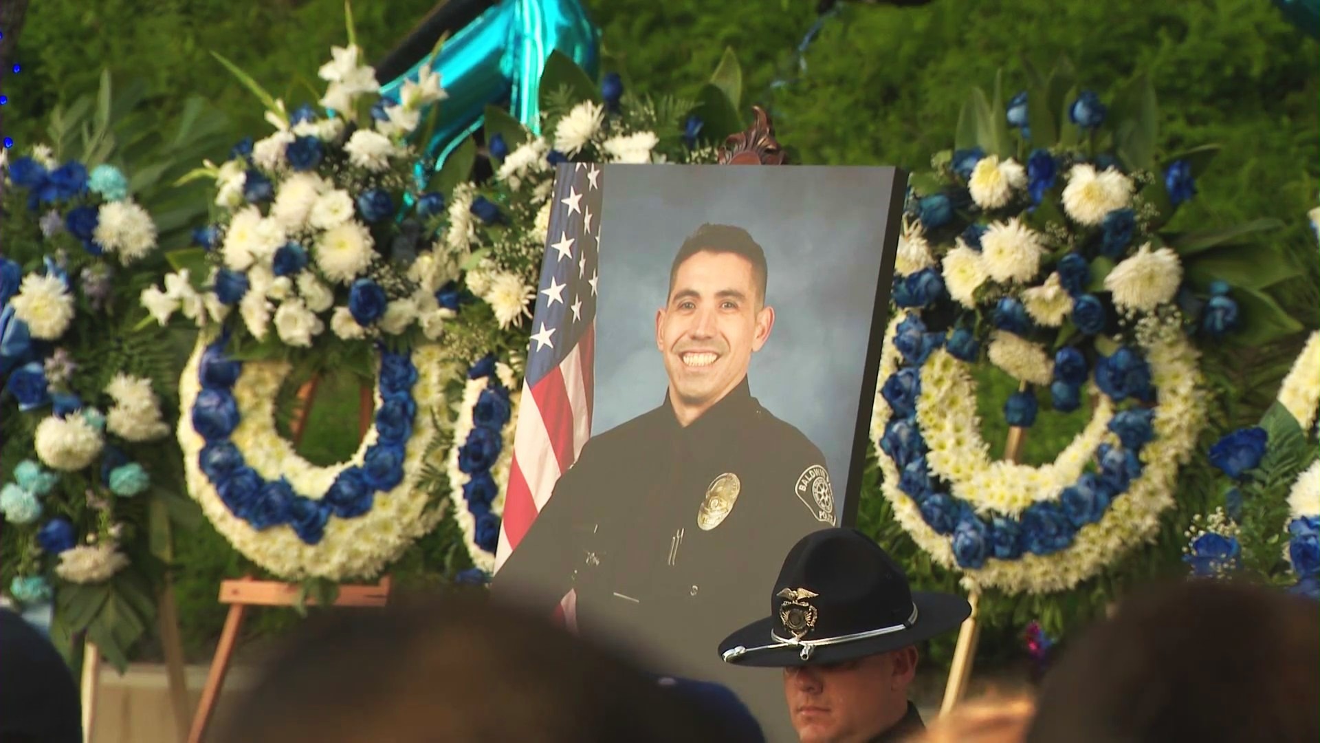 Loved ones, colleagues and community members gathered for a candlelight vigil to honor the life of Officer Samuel Riveros outside Baldwin Park City Hall on June 6, 2025. (KTLA)