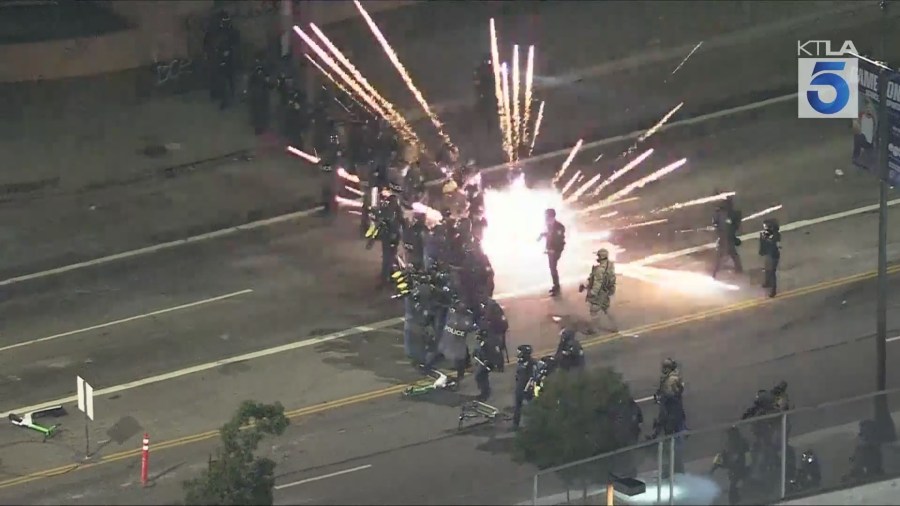 Protestors threw fireworks as federal officers created a skirmish line to push back protestors gathered in downtown Los Angeles on Saturday night over ICE raids happening in SoCal. Gil Leyvas reports from Sky5 on June 7, 2025. (KTLA)