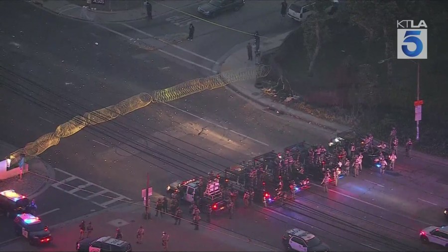 Federal officers created a skirmish line to push back protestors gathered in downtown Los Angeles on Saturday night over ICE raids happening in SoCal. Gil Leyvas reports from Sky5 on June 7, 2025. (KTLA)