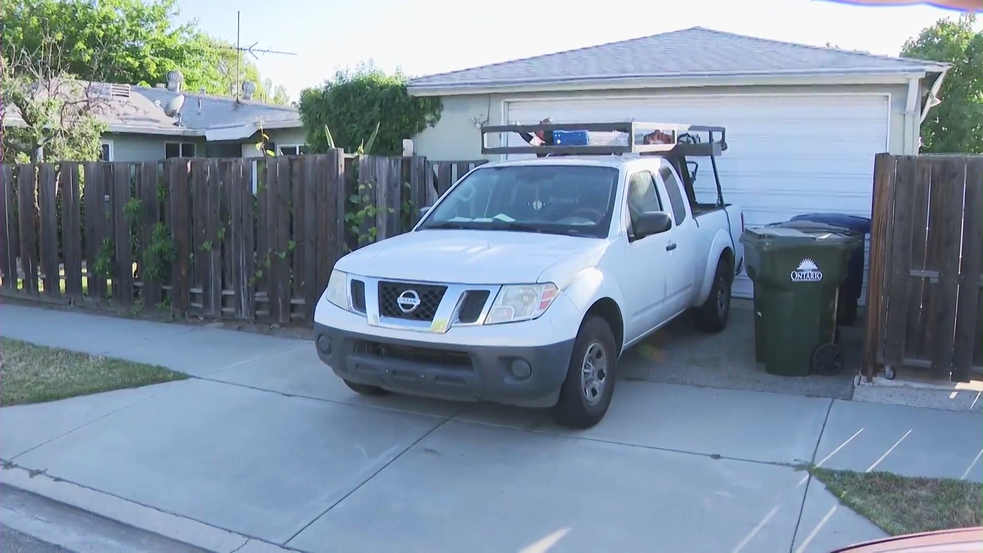 The work truck and tools left behind at an Ontario home after two gardeners were reportedly taken by federal immigration agents while mowing the lawn on June 19, 2025. (KTLA)
