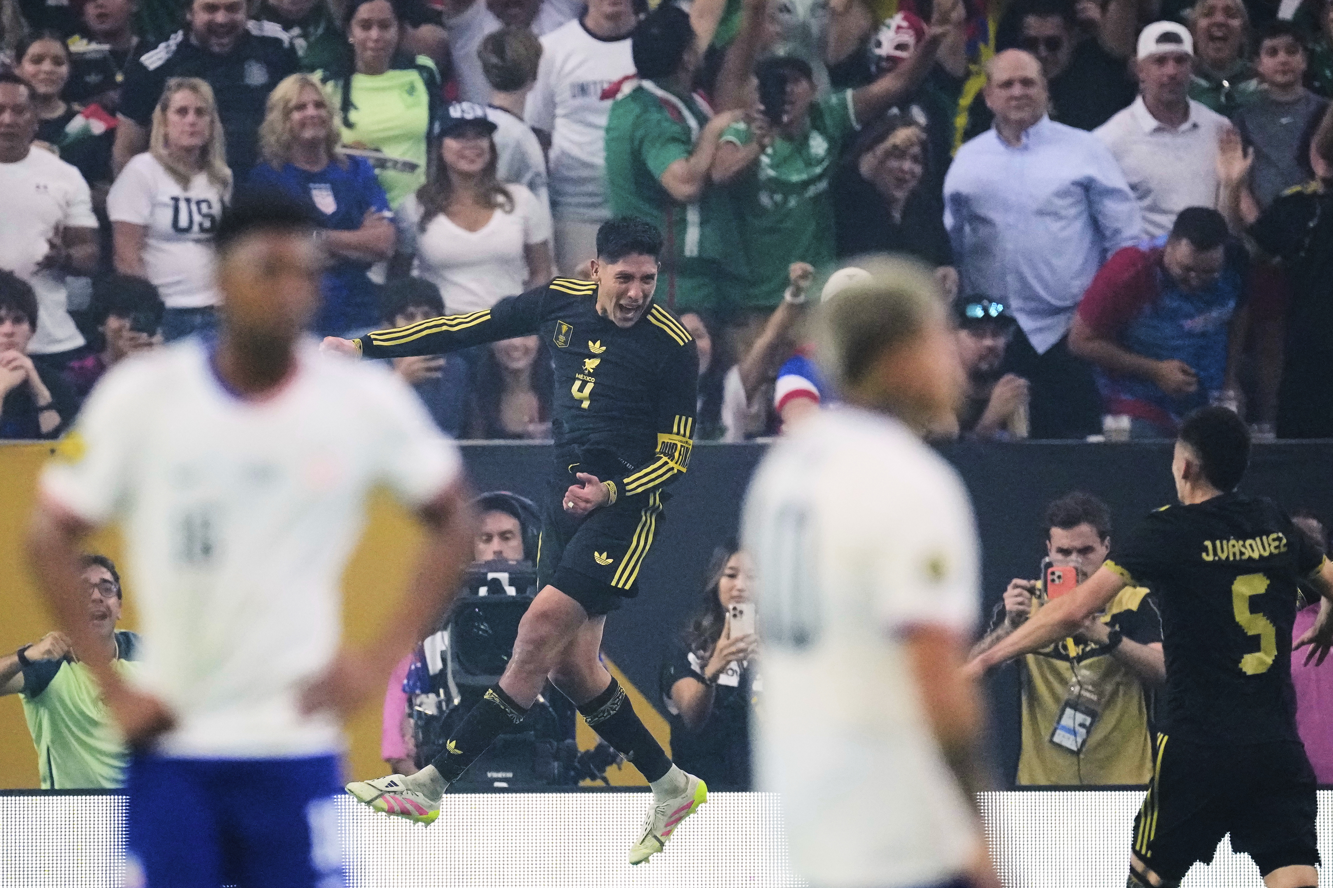 Mexico midfielder Edson Álvarez (4) leaps as he celebrates after scoring against the United States as Johan Vásquez (5) looks on in the second half of the CONCACAF Gold Cup final soccer match in Houston, Sunday, July 6, 2025. (AP Photo/David J. Phillip)