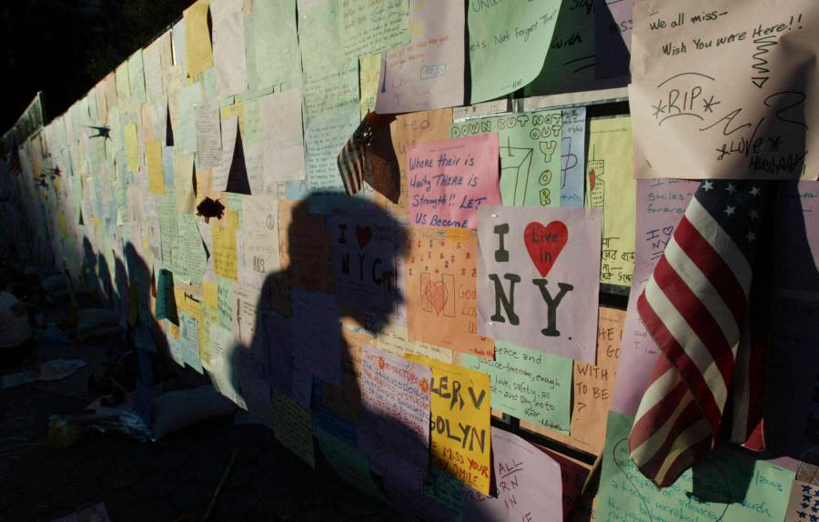FILE - Late evening shadows are cast across messages left by visitors on a wall standing in Union Square Park Wednesday, Sept. 11, 2002, in New York, to mark the one year anniversary of the Sept. 11 terrorist attacks. (AP Photo/Beth A. Keiser, File)