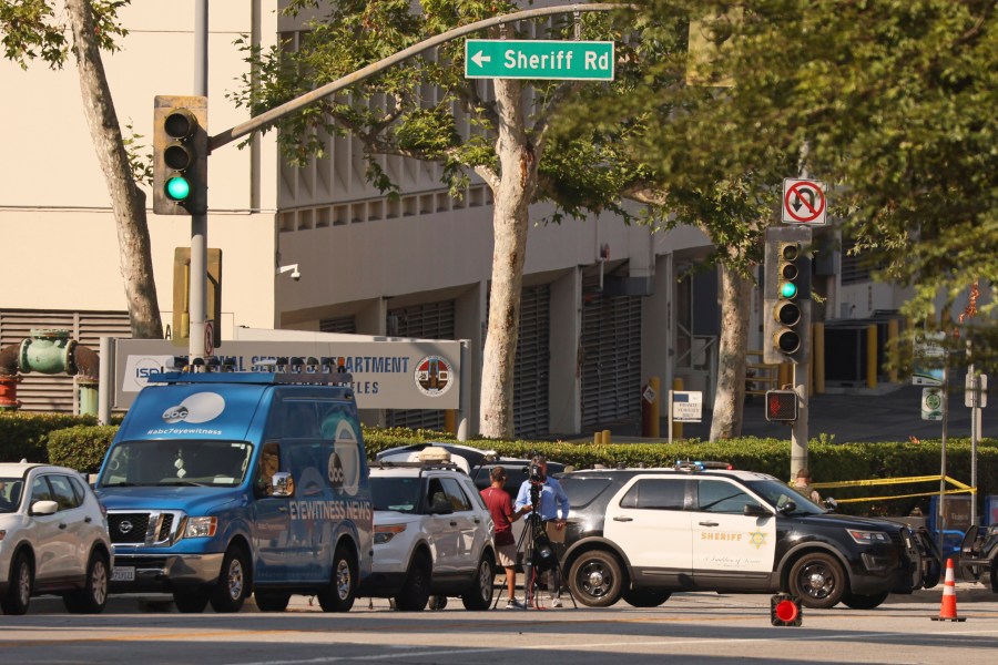 Media and law enforcement stage near the site of an explosion at the LA County Sheriff's Special Operations Bureau on Friday, July 18, 2025, in Los Angeles. (AP Photo/Etienne Laurent)