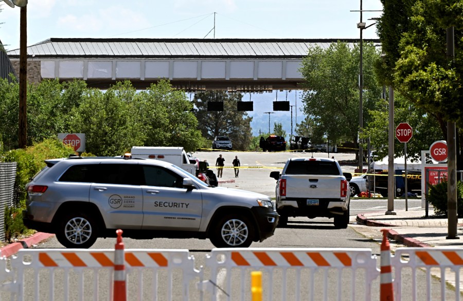Police are seen walking toward the valet area of the the Grand Sierra Resort where a shooting occurred in Reno, Nev., Monday, July 28, 2025. (AP Photo/Andy Barron)