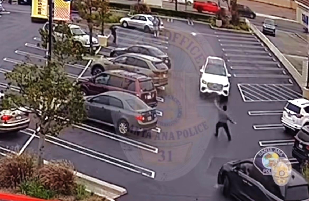 Surveillance video showed the victim trying to stop the robbery suspects from fleeing in a Mercedes GLS 450 SUV before he was run over on June 4, 2025. (Santa Ana Police Department)