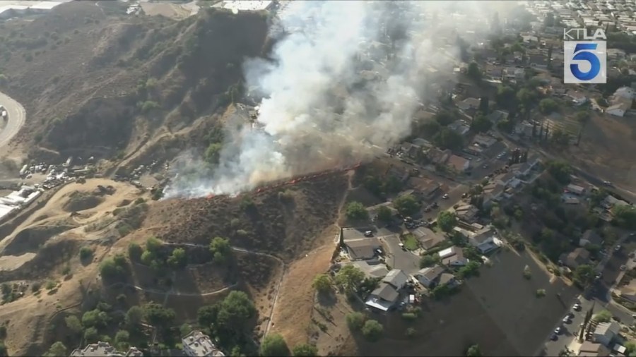 Firefighters battled a grass fire that ignited on a hillside near homes in Pacoima on July 11, 2025. (KTLA)