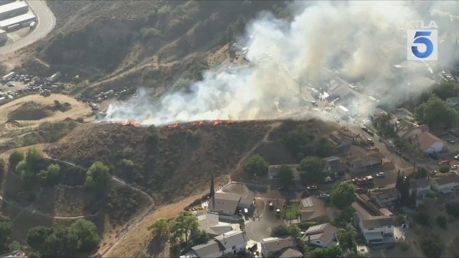 Firefighters battled a grass fire that ignited on a hillside near homes in Pacoima on July 11, 2025. (KTLA)