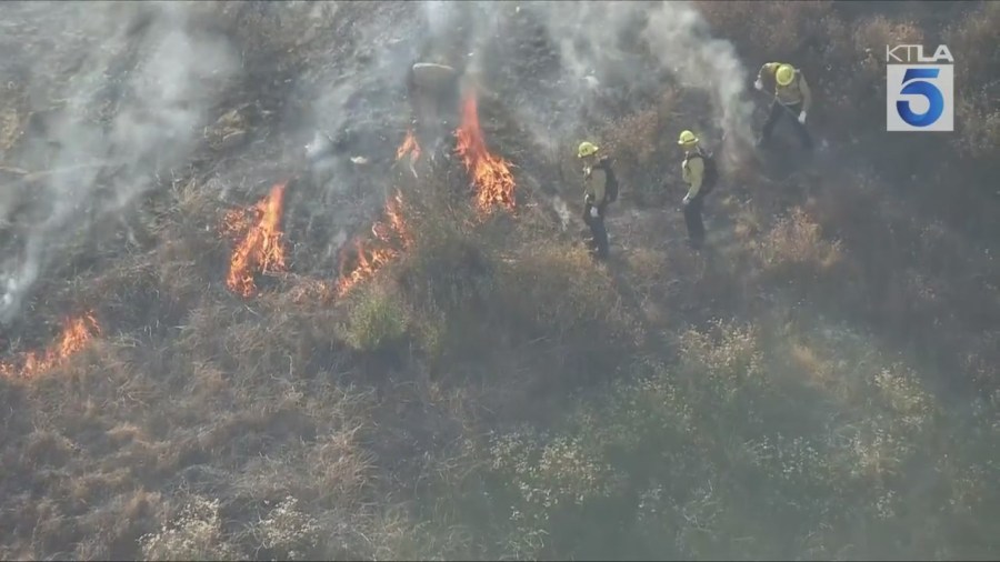 Firefighters battled a grass fire that ignited on a hillside near homes in Pacoima on July 11, 2025. (KTLA)