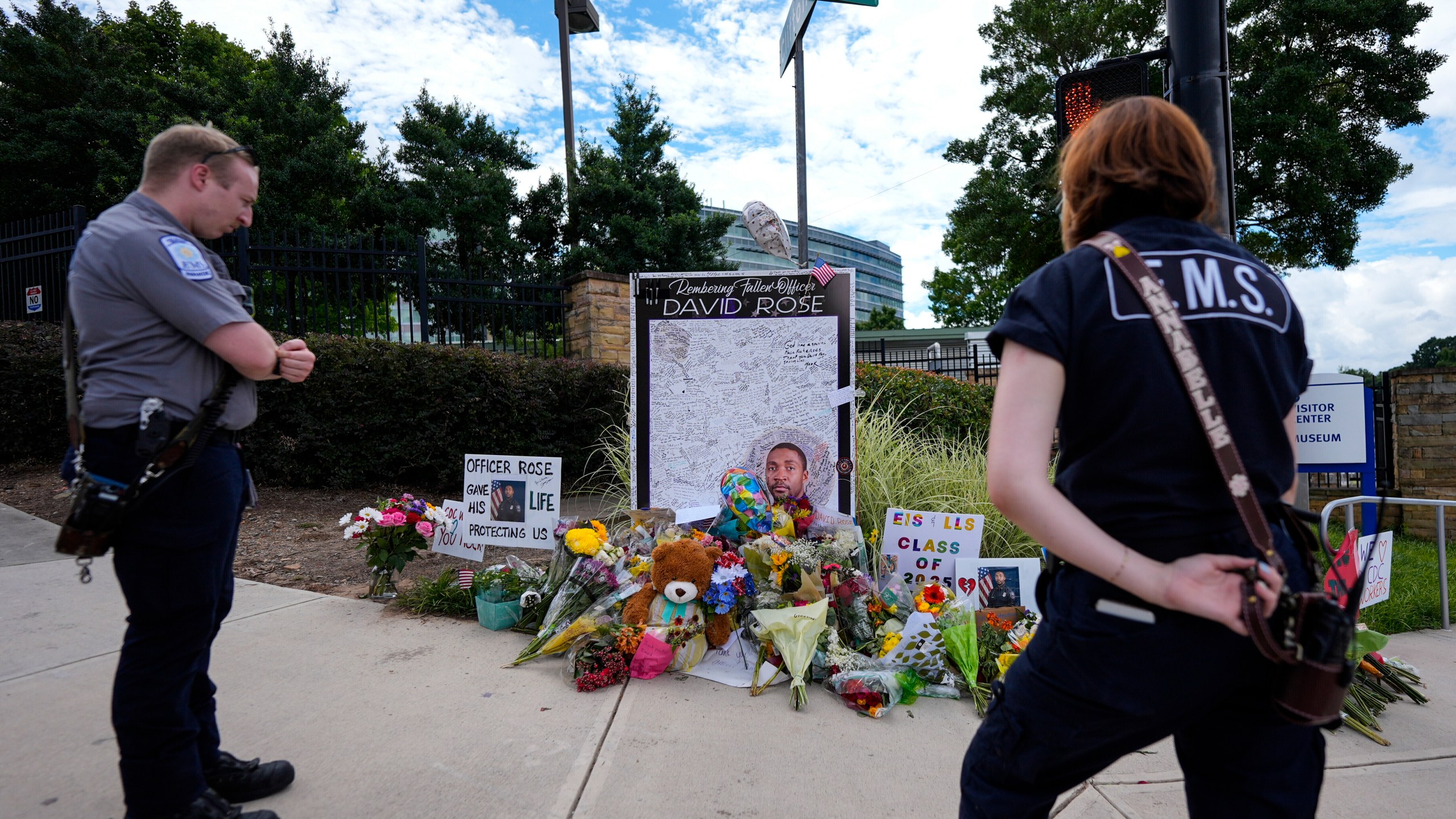 CORRECTS THAT OFFICER WAS KILLED, NOT WOUNDED - A memorial is seen in the aftermath of a shooting near the CDC where DeKalb County Police Officer David Rose was killed while responding, Wednesday, Aug. 13, 2025, in Atlanta. (AP Photo/Mike Stewart)