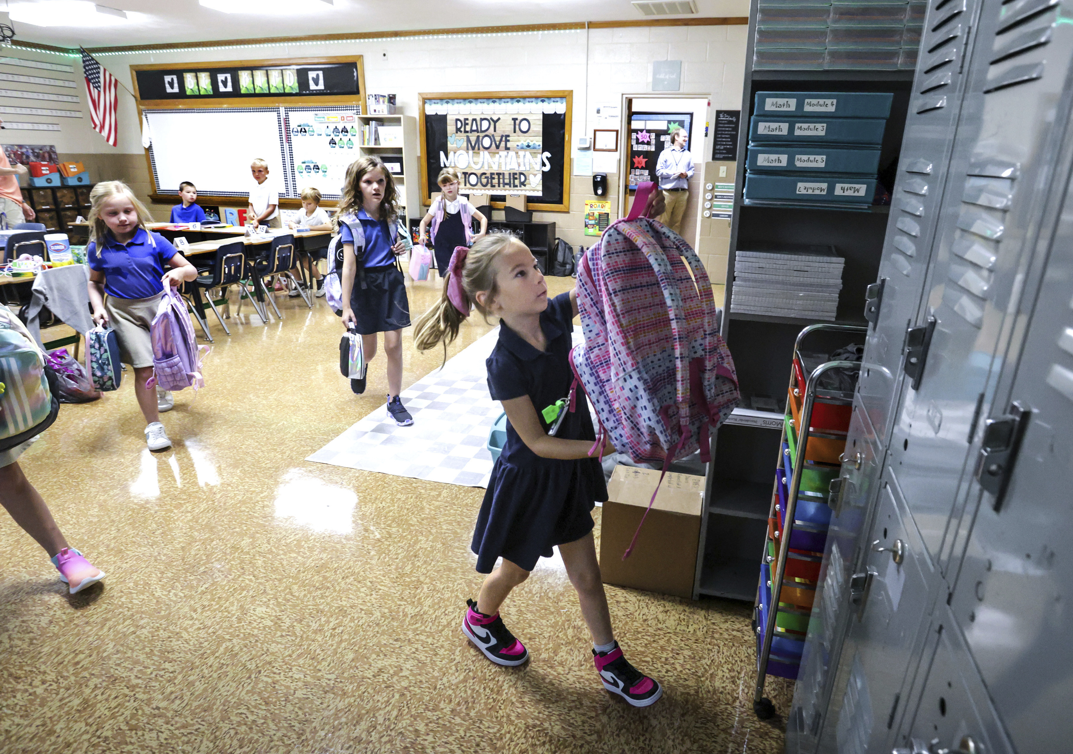 Savannah Knott hangs up her backpack for the day on the first day in her second grade classroom at Mary Carrico Catholic School, Tuesday, Aug. 12, 2025, in Knottsville, Ky. (Greg Eans/The Messenger-Inquirer via AP)