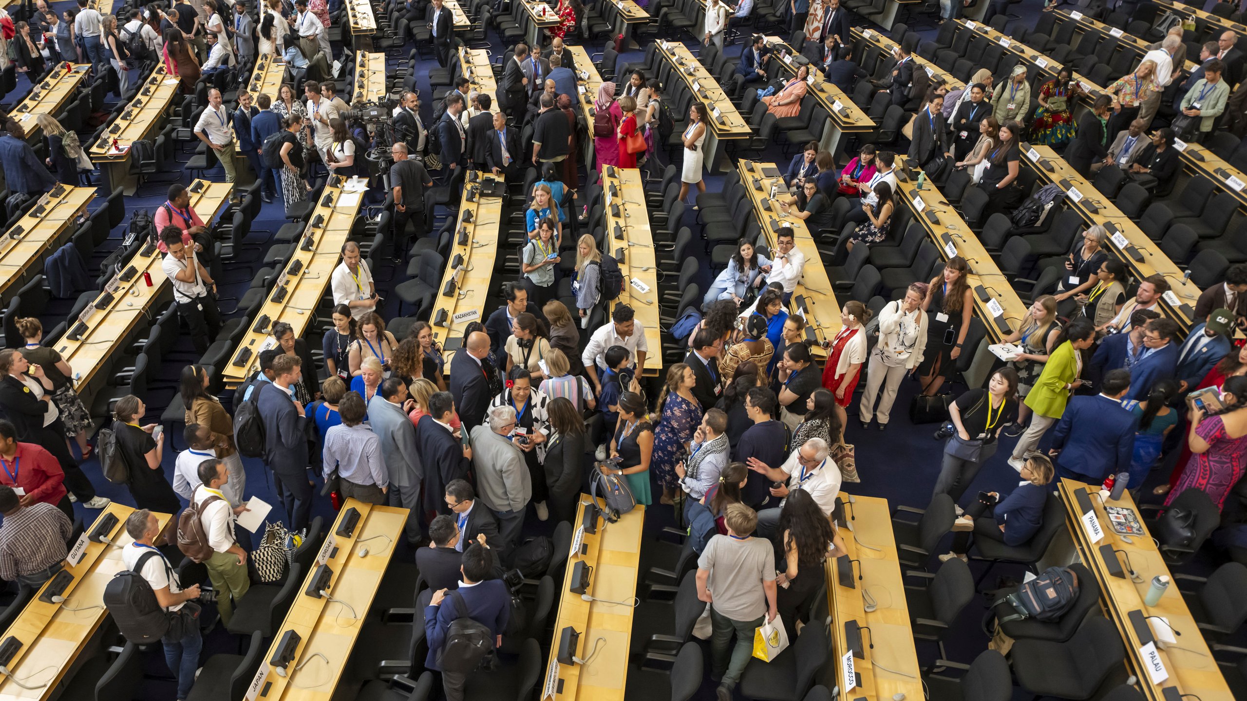 Delegates reacts during a plenary session of Second Part of the Fifth Session of the Intergovernmental Negotiating Committee on Plastic Pollution (INC-5.2), at the European headquarters of the United Nations in Geneva, Switzerland, Thursday, Aug. 14, 2025. (Martial Trezzini/Keystone via AP)