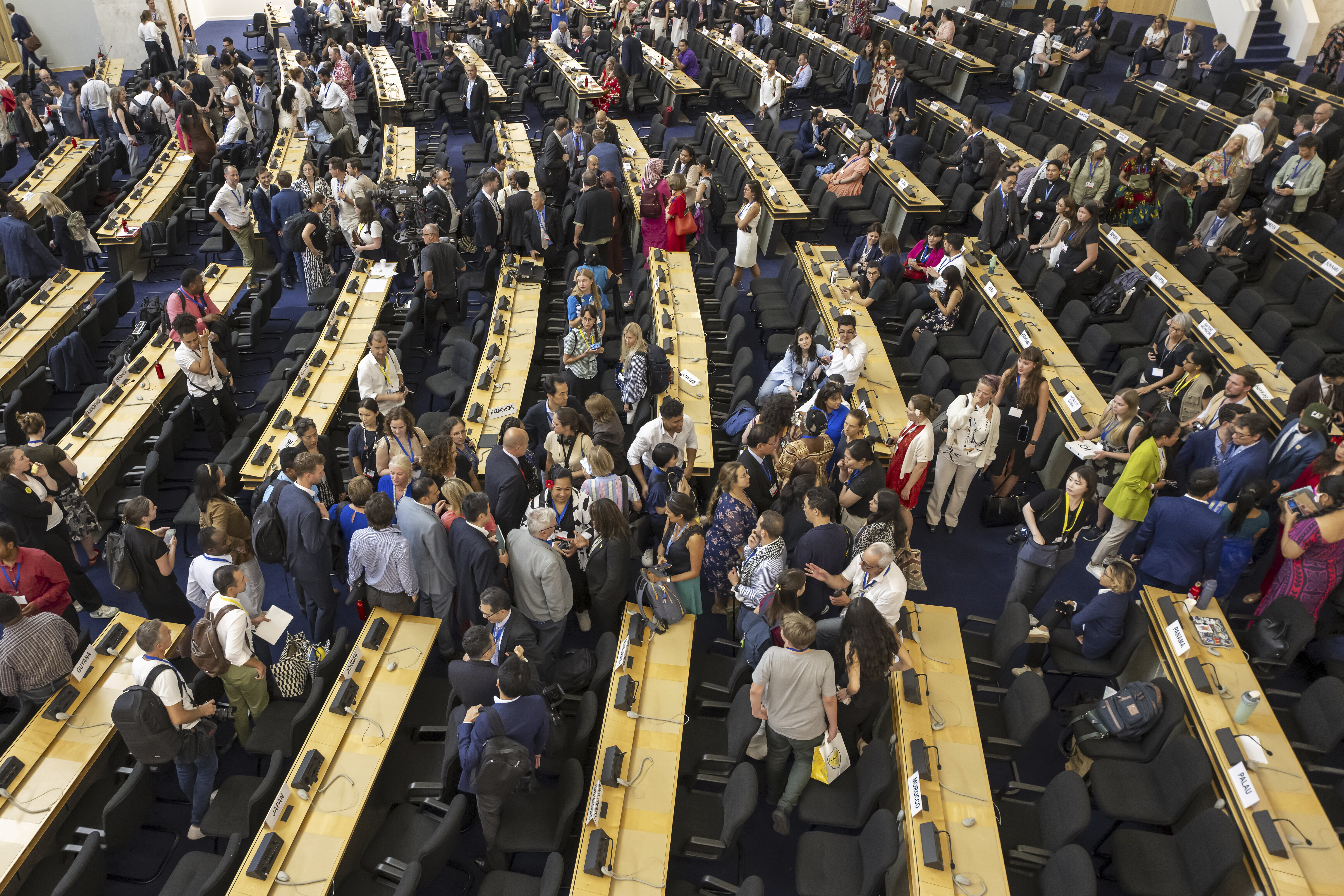 Delegates reacts during a plenary session of Second Part of the Fifth Session of the Intergovernmental Negotiating Committee on Plastic Pollution (INC-5.2), at the European headquarters of the United Nations in Geneva, Switzerland, Thursday, Aug. 14, 2025. (Martial Trezzini/Keystone via AP)
